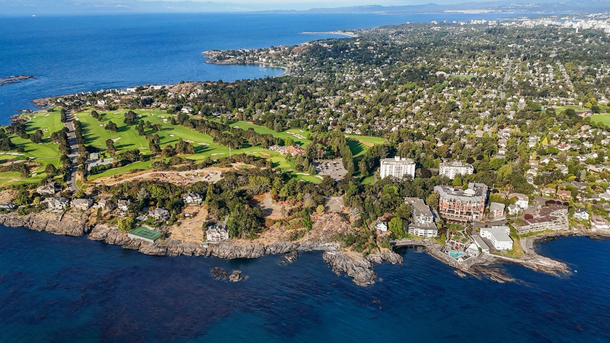 The rocky shoreline and pocket cove at the foot of the property